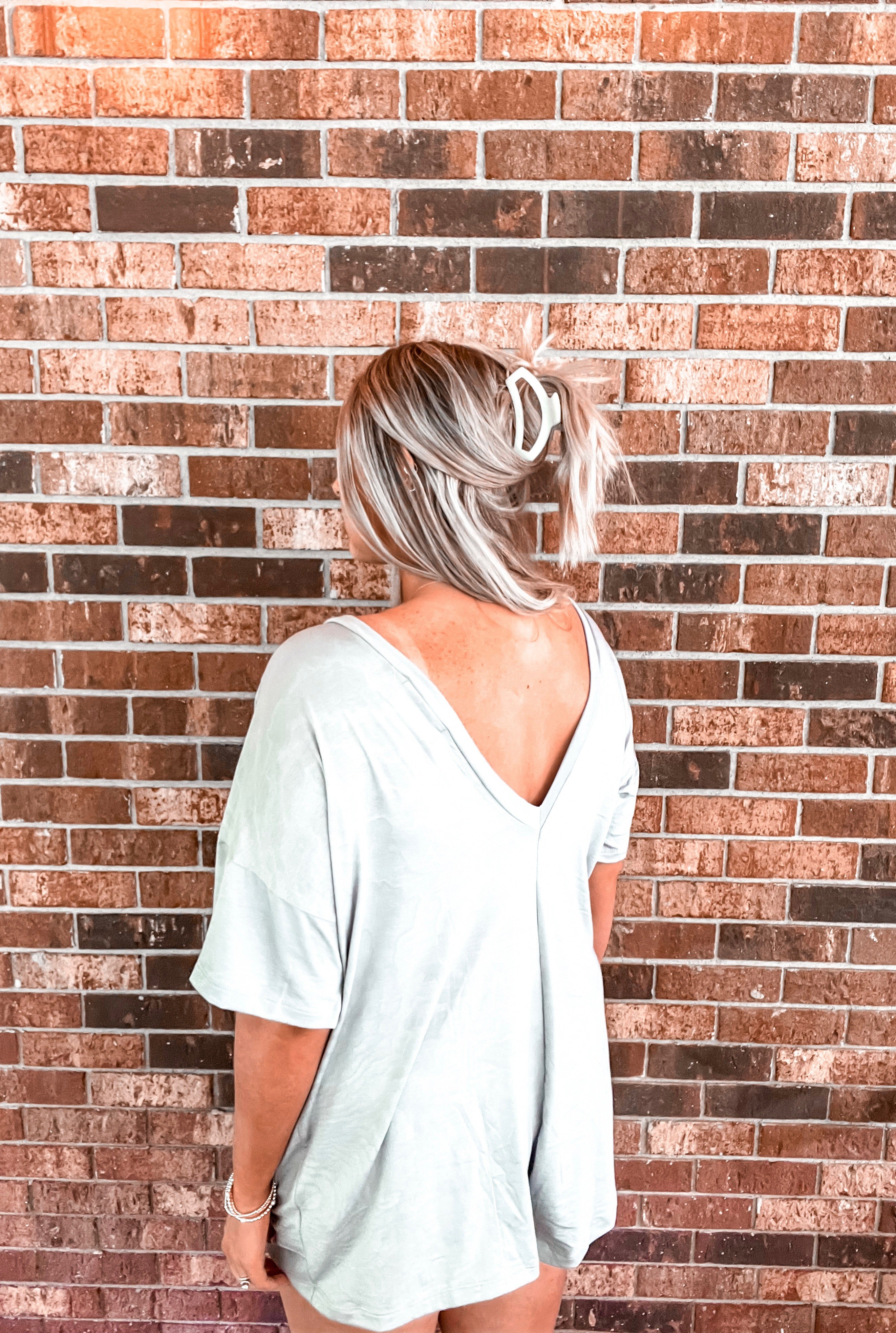 Indulge in relaxed elegance with this slate gray romper, boasting an oversized, flowy fit for maximum comfort and style. Featuring convenient front pockets and a chic v-neck detail at the back, this piece effortlessly merges fashion and functionality. Perfect for lounging at home or stepping out with a touch of effortless sophistication
